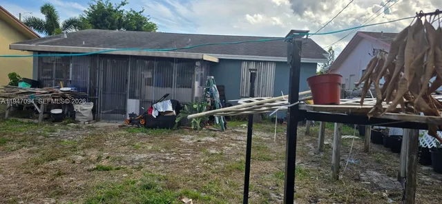 a view of a patio with table and chairs with wooden fence