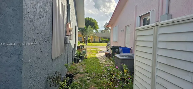 a view of a house with a small yard and wooden floor