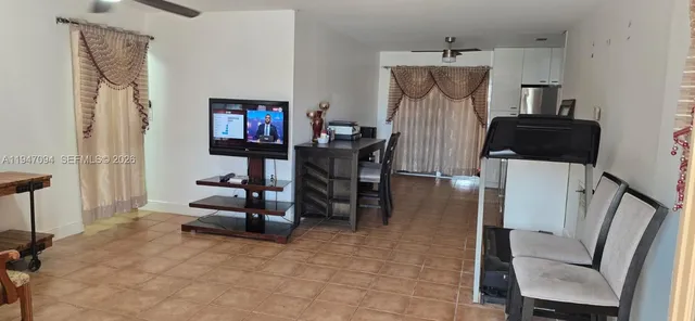 a living room with furniture a desk and chair with wooden floor
