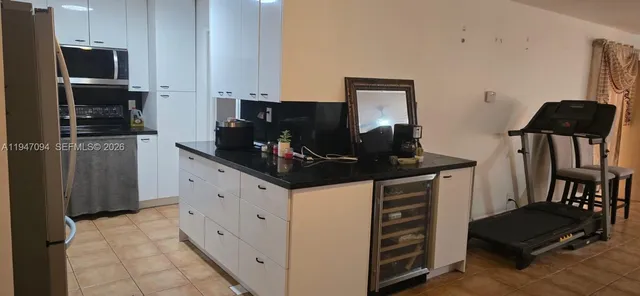 a kitchen with stainless steel appliances a stove refrigerator and microwave