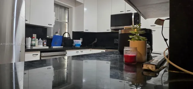 a view of living room with furniture and flat screen tv