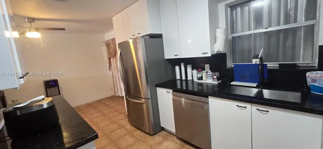 a kitchen with a sink and refrigerator