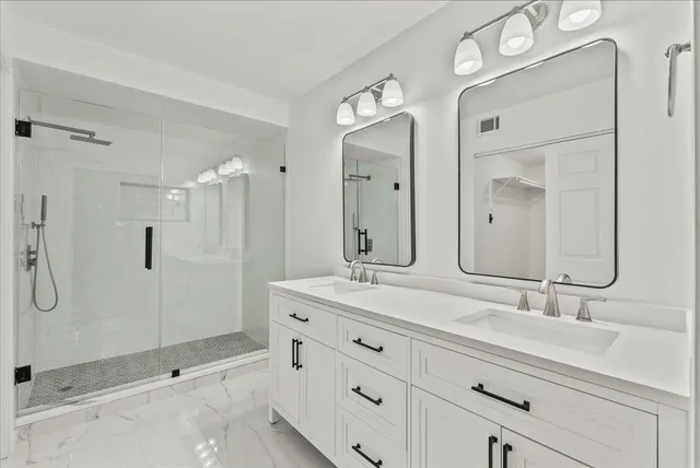 a bathroom with a shower sink and mirror
