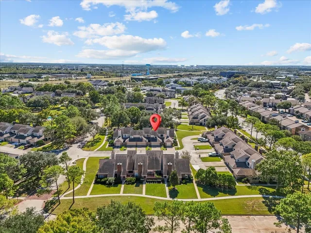 an aerial view of residential houses with outdoor space and swimming pool