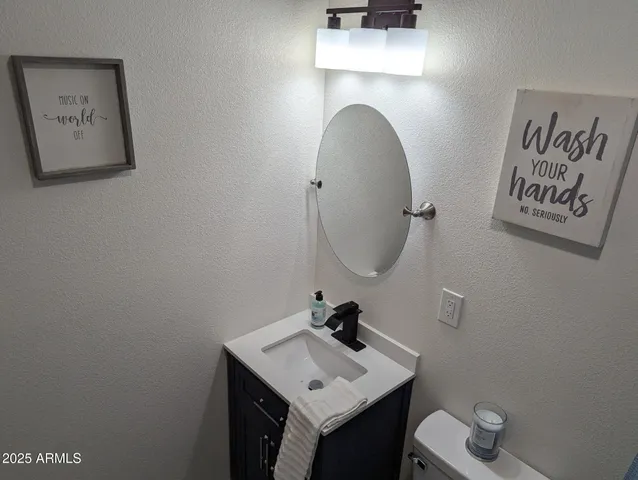 a bedroom with a bed and a wall painting