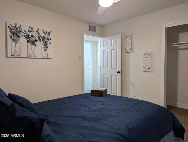 a bedroom with a bed and cupboard