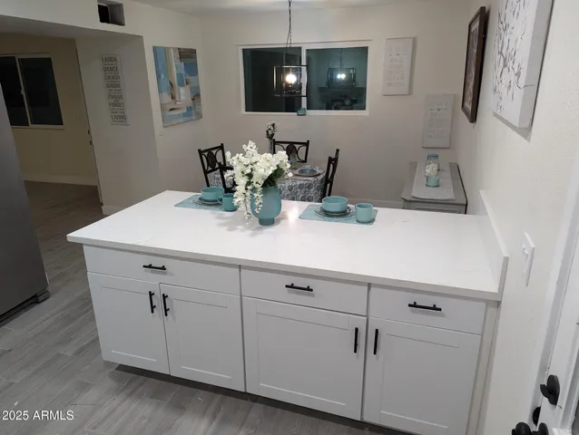 a bedroom with a bed and painting on the wall