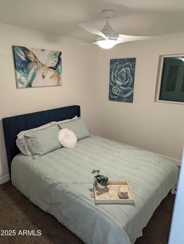 a bedroom with a bed and wall painting