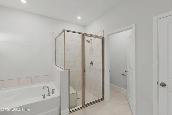 a bathroom with a bathtub and a shower
