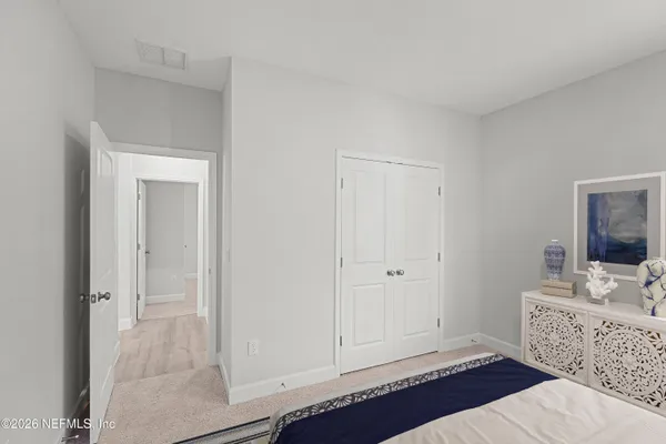 a bedroom with a large bed and a dresser