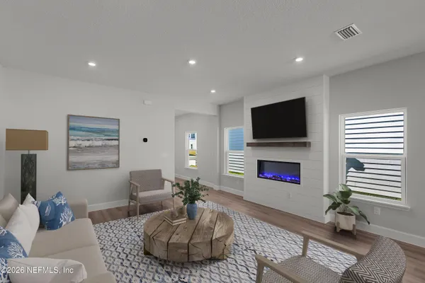 a living room with furniture and a flat screen tv