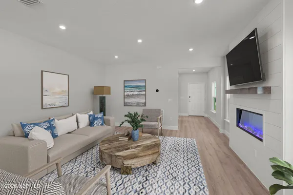 a living room with furniture fireplace and flat screen tv