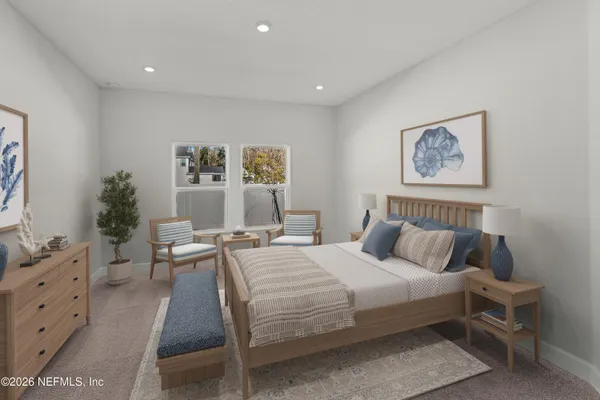 a bedroom with a large bed and a window