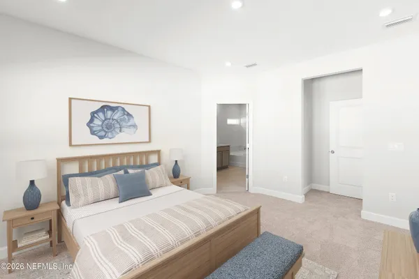 a bedroom with a bed and a painting on the wall