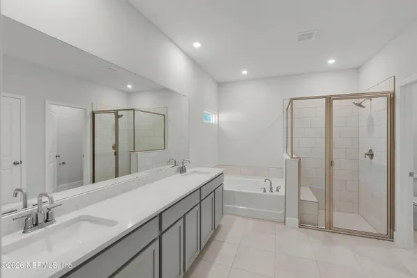 a spacious bathroom with a double vanity sink mirror double and shower