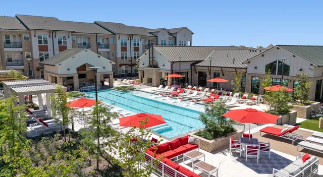 a view of a patio with a dining table and chairs under an umbrella