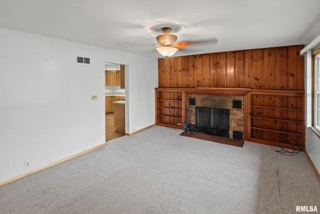 a view of empty room with furniture and fireplace