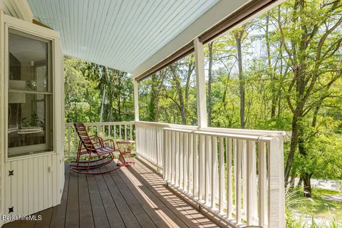 a balcony with wooden floor and outdoor space