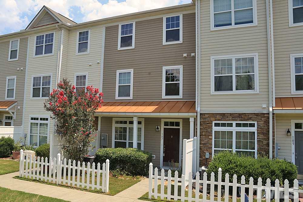 11701 Coppergate Drive, Unit 107 Raleigh, NC 27614 - Photo 1 of 13 a front view of a house with a garden