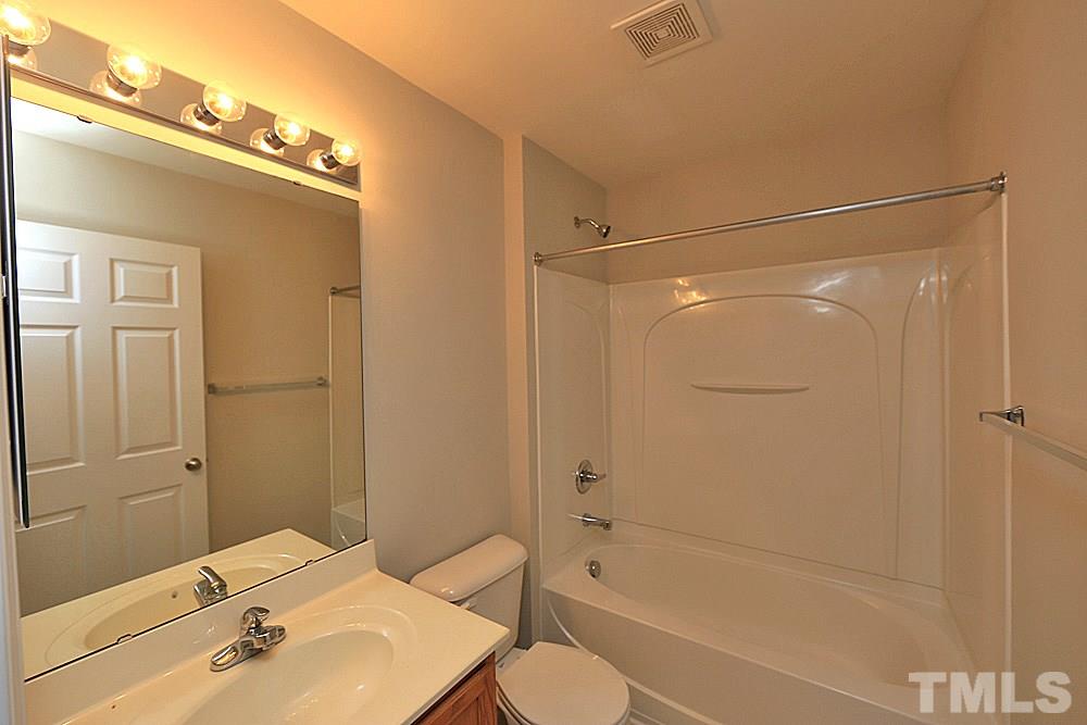 11701 Coppergate Drive, Unit 107 Raleigh, NC 27614 - Photo 12 of 13 a bathroom with a shower a sink and a mirror