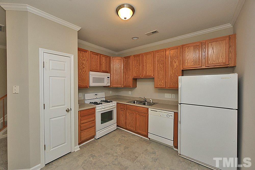 11701 Coppergate Drive, Unit 107 Raleigh, NC 27614 - Photo 3 of 13 a kitchen with a refrigerator sink and cabinets