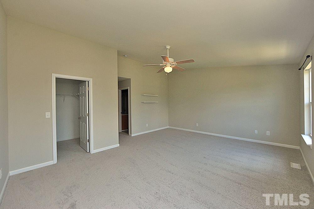 11701 Coppergate Drive, Unit 107 Raleigh, NC 27614 - Photo 7 of 13 a view of an empty room with a fan