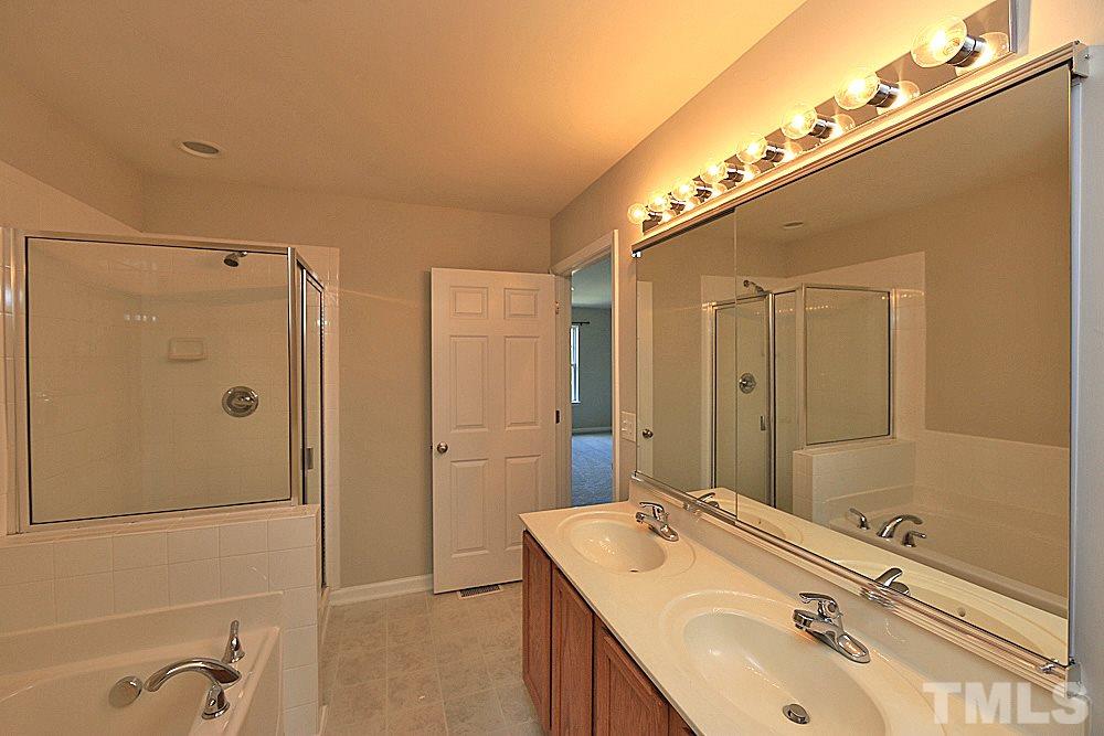 11701 Coppergate Drive, Unit 107 Raleigh, NC 27614 - Photo 9 of 13 a bathroom with a sink shower and a mirror