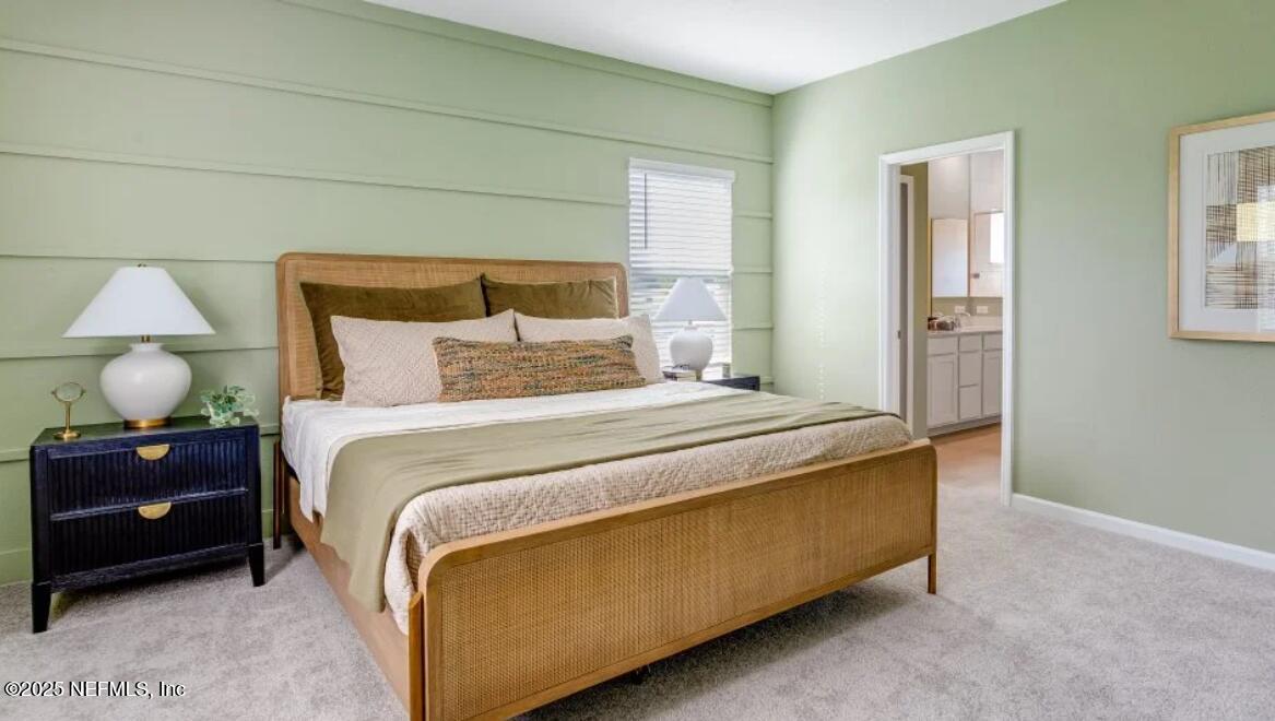 3203 Tupelo Loop Green Cove Springs, FL 32043 - Photo 13 of 22 a bedroom with a bed and a lamp