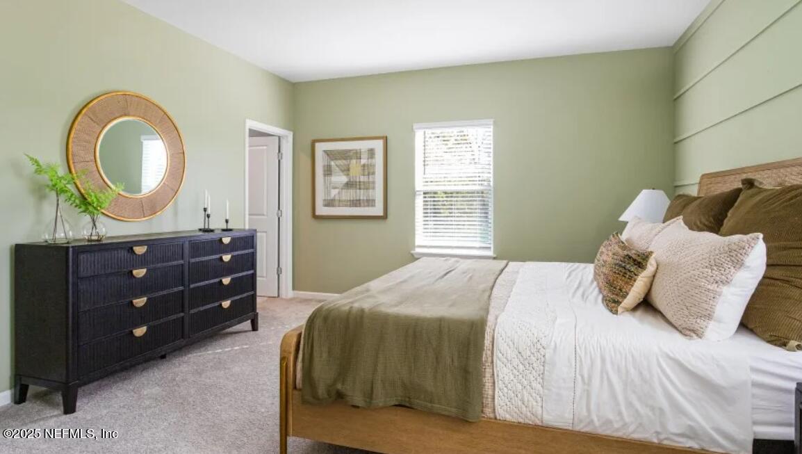 3203 Tupelo Loop Green Cove Springs, FL 32043 - Photo 14 of 22 a bedroom with a bed and a dresser