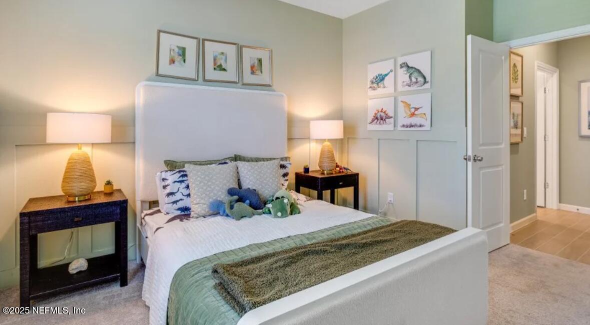 3203 Tupelo Loop Green Cove Springs, FL 32043 - Photo 16 of 22 a bedroom with a bed and a lamp