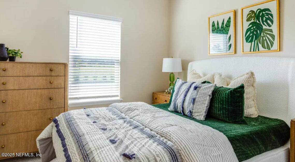 3203 Tupelo Loop Green Cove Springs, FL 32043 - Photo 17 of 22 a bedroom with a bed and a window