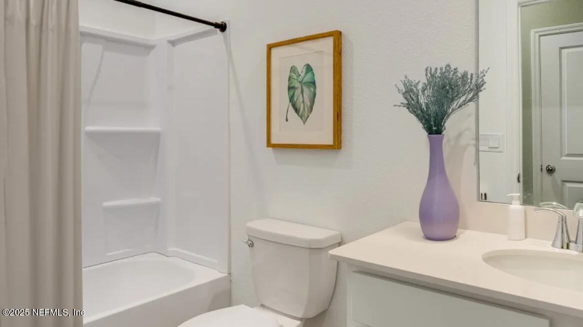 3203 Tupelo Loop Green Cove Springs, FL 32043 - Photo 19 of 22 a bathroom with a sink and a toilet