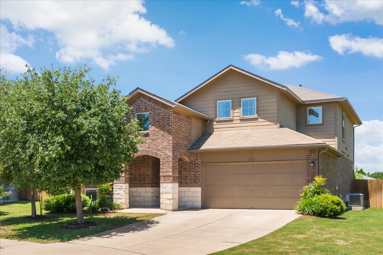717 Kaluga Trail Leander, TX 78641 - Photo 2 of 40 a front view of a house with a yard and garage