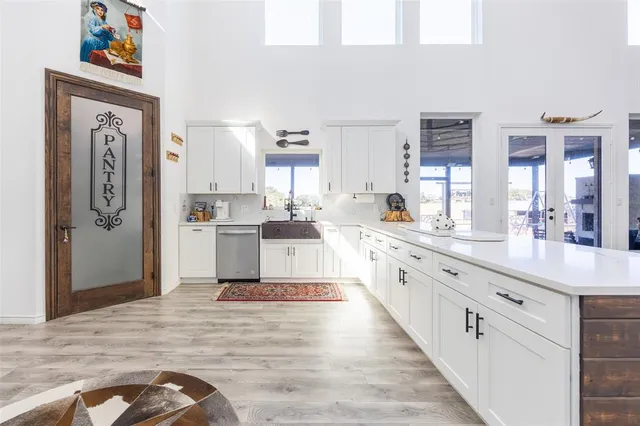 a bathroom with double vanity sink and a mirror