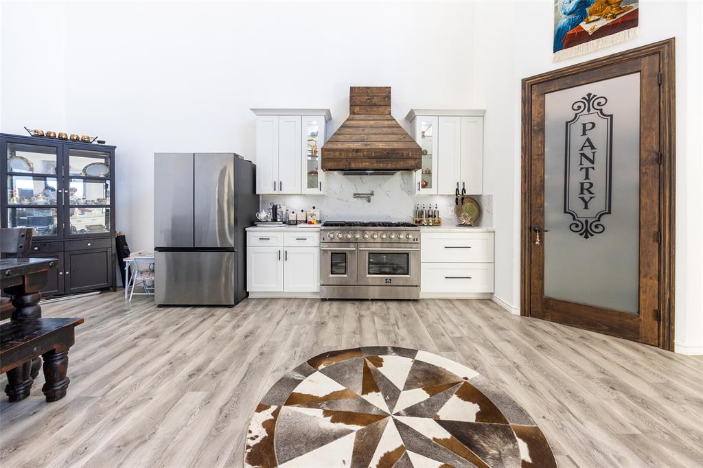 2630 Rockhill Road Aubrey, TX 76227 - Photo 13 of 38 a kitchen with stainless steel appliances granite countertop a refrigerator and a stove top oven