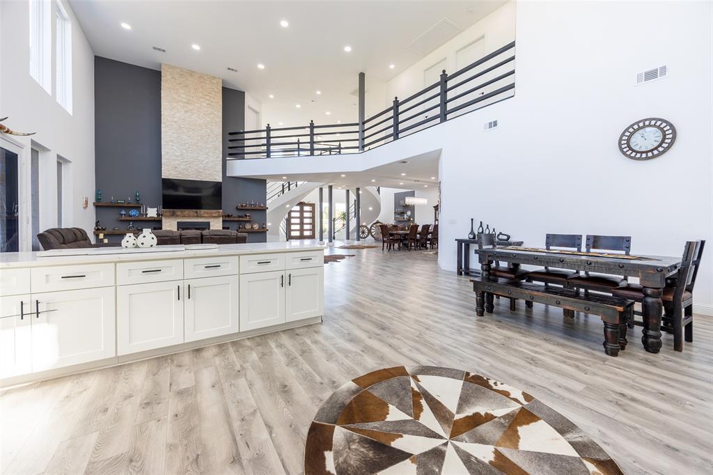 2630 Rockhill Road Aubrey, TX 76227 - Photo 38 of 38 a large white kitchen with lots of counter space and painting on the wall