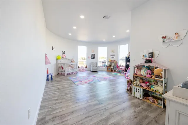 a large white kitchen with lots of counter space and painting on the wall