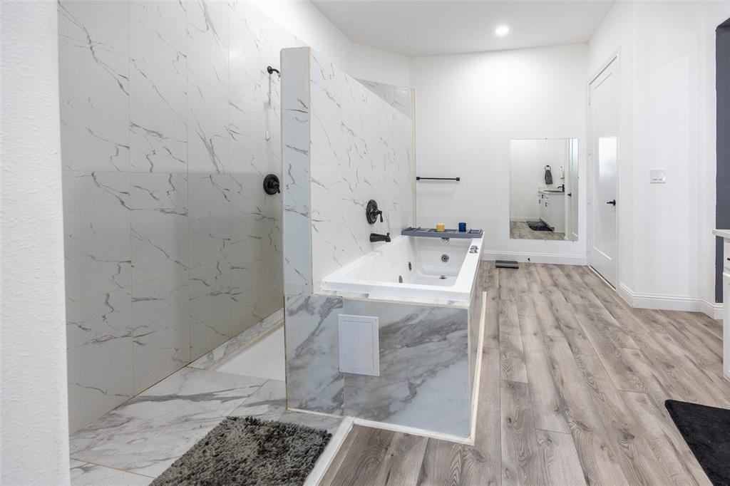 2630 Rockhill Road Aubrey, TX 76227 - Photo 18 of 38 a bathroom with a sink a mirror and shower