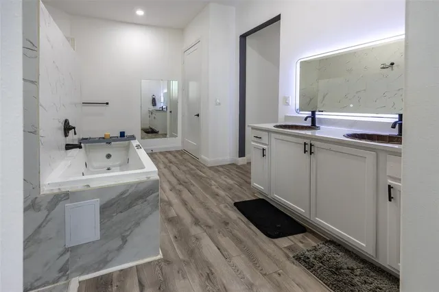a bathroom with a sink a mirror and shower