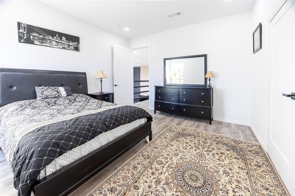 2630 Rockhill Road Aubrey, TX 76227 - Photo 23 of 38 a bedroom with a bed and a couch