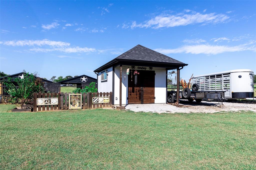 2630 Rockhill Road Aubrey, TX 76227 - Photo 24 of 38 a view of a house with a yard and sitting area