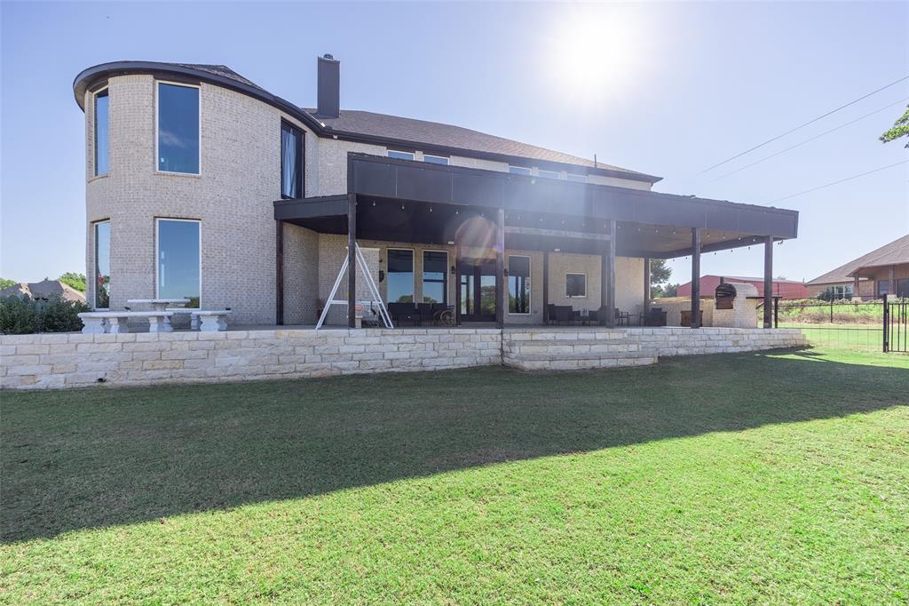 2630 Rockhill Road Aubrey, TX 76227 - Photo 3 of 38 a view of a house with a backyard