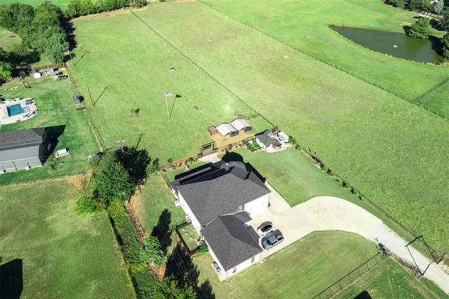 an aerial view of a house with outdoor space patio and swimming pool