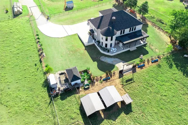 an aerial view of a house with a yard