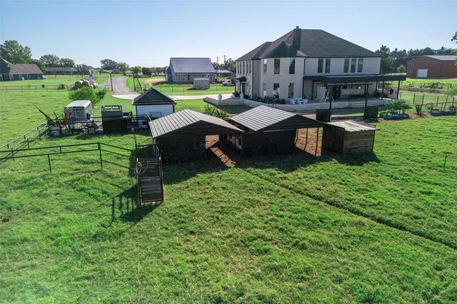 an aerial view of a house with outdoor space and street view