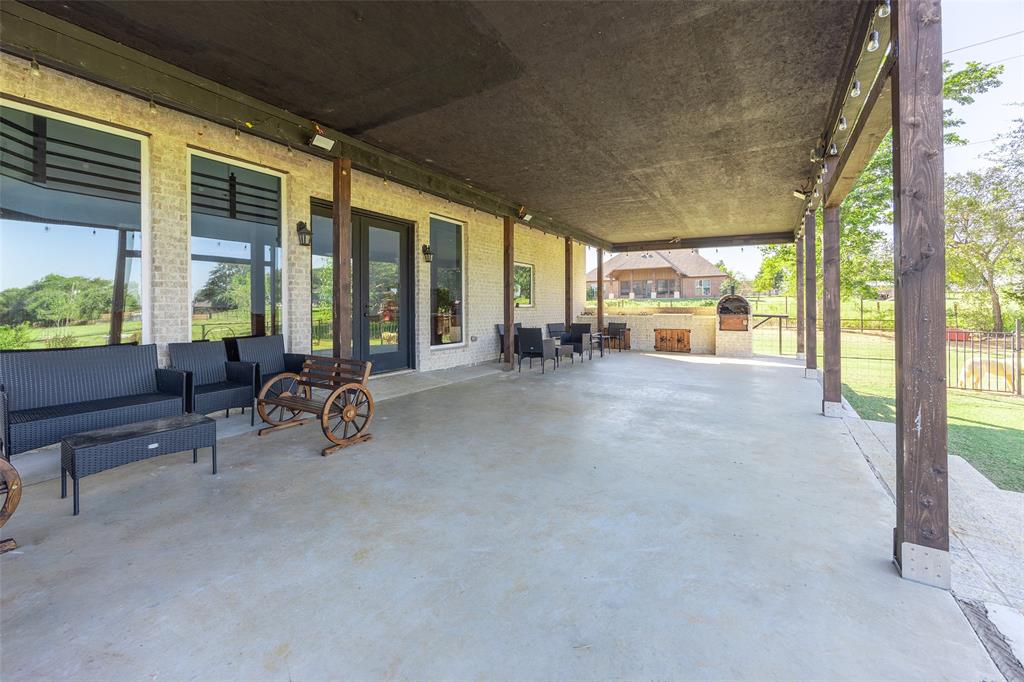2630 Rockhill Road Aubrey, TX 76227 - Photo 4 of 38 a view of a livingroom with couch and floor to ceiling window