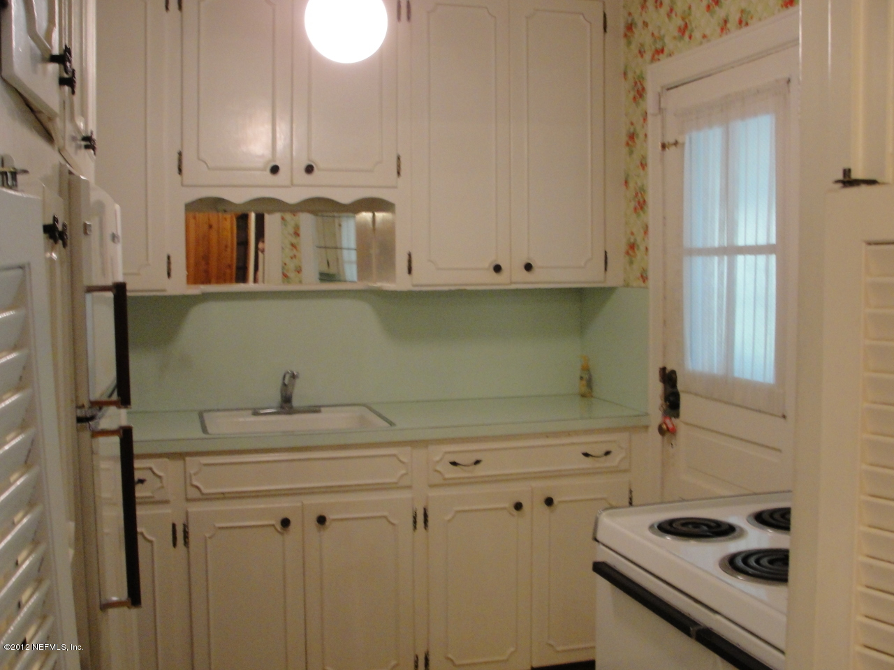 4656 Manchester Road Jacksonville, FL 32210 - Photo 11 of 31 a bathroom with a sink and a mirror