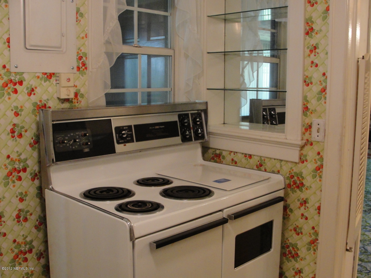 4656 Manchester Road Jacksonville, FL 32210 - Photo 12 of 31 a kitchen with a stove and a refrigerator
