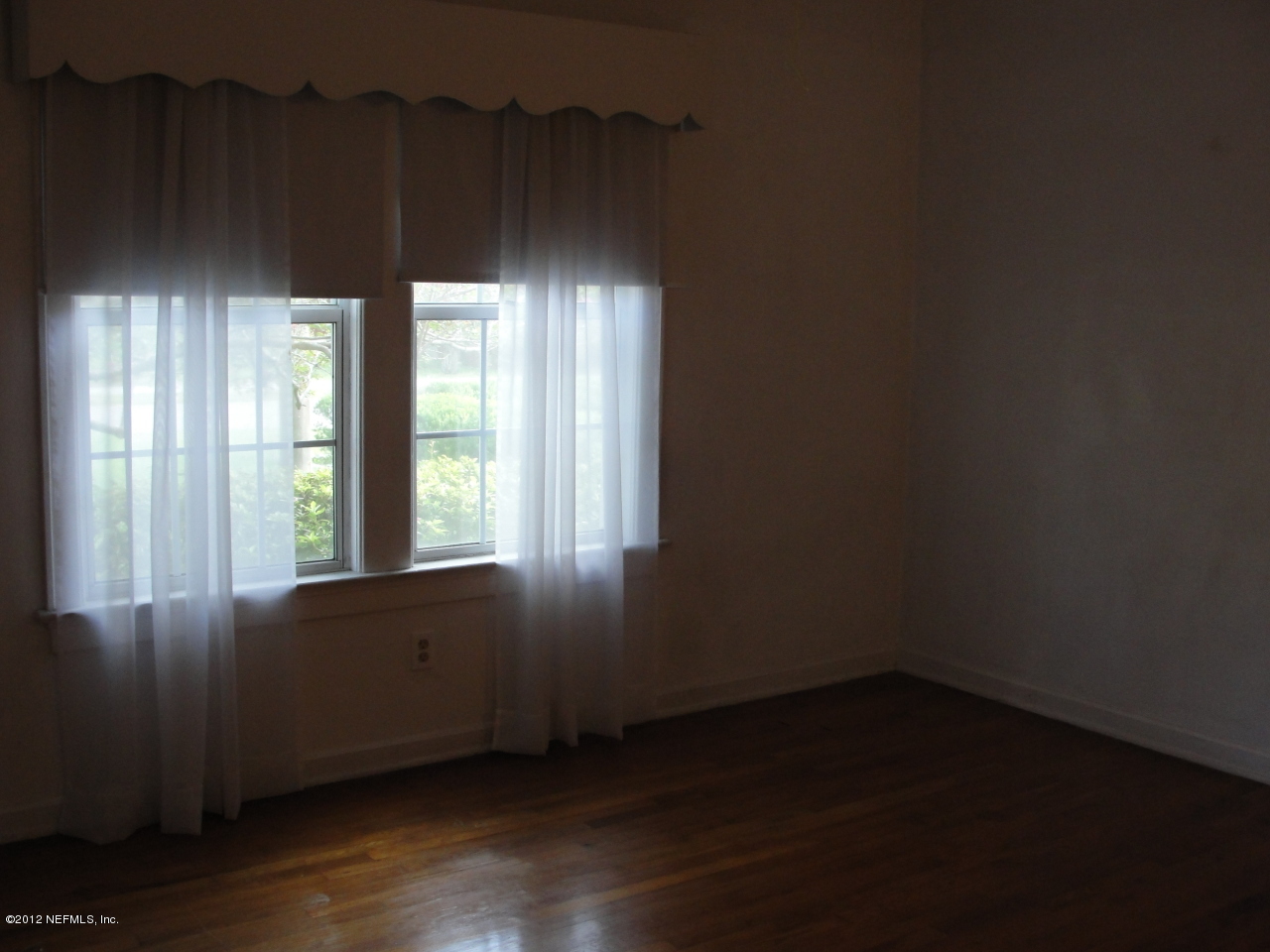 4656 Manchester Road Jacksonville, FL 32210 - Photo 14 of 31 an empty room with wooden floor and windows