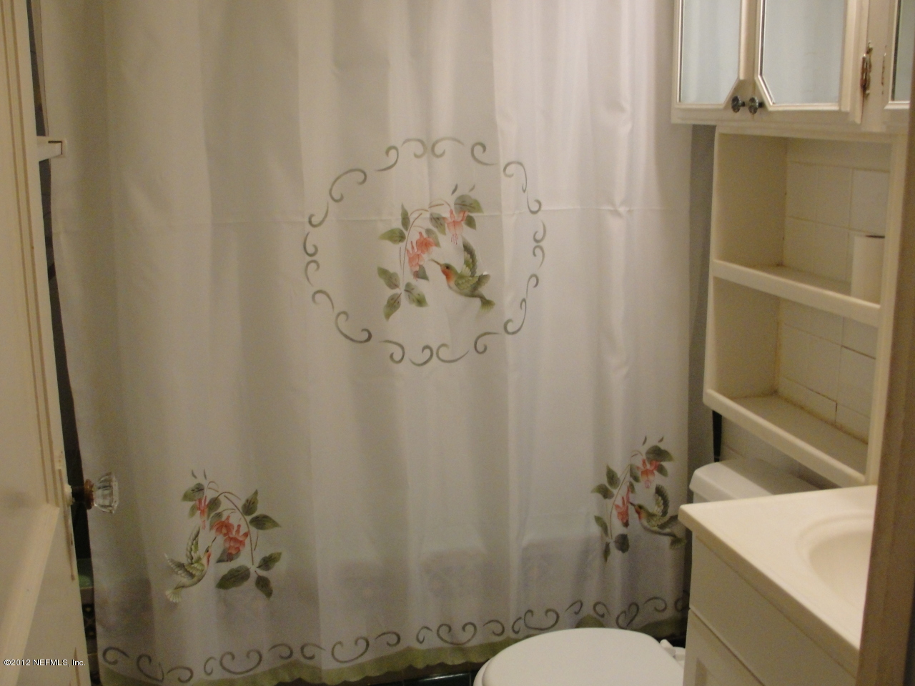 4656 Manchester Road Jacksonville, FL 32210 - Photo 15 of 31 a bathroom with a shower curtain and a toilet